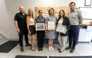 Mariia Kupriianova and Carol Petrini stop by Silcotech to award Raphael Boettger, Manpreet Kaur, Isolde Boettger, and Yogesh Chauhan with recognition for helping to make Velocity 2026 a massive success.